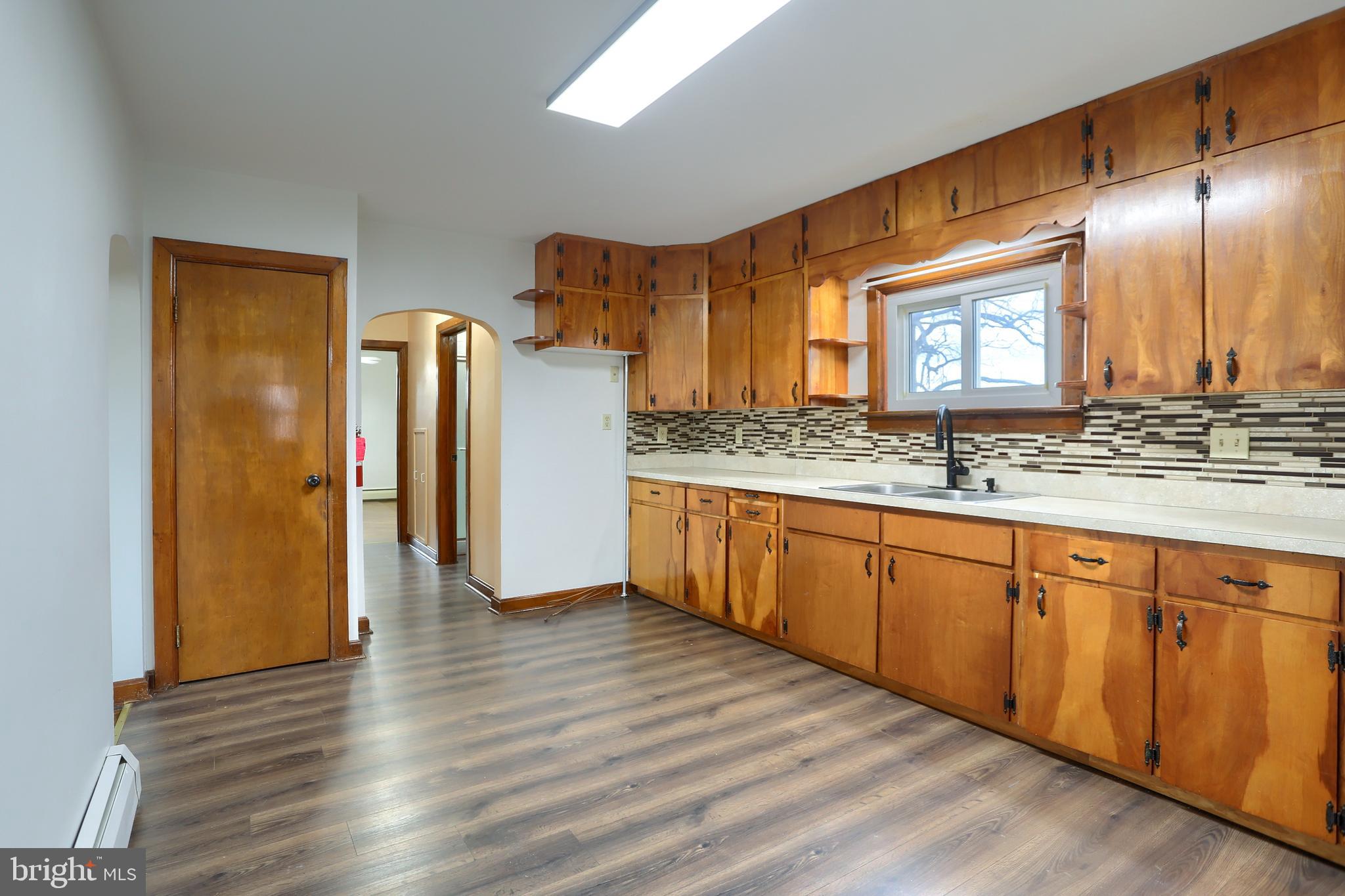 338 Locust Street Halifax, PA 17032 - Photo 11 of 43 a kitchen with stainless steel appliances granite countertop a refrigerator a sink dishwasher and wooden cabinets with wooden floor