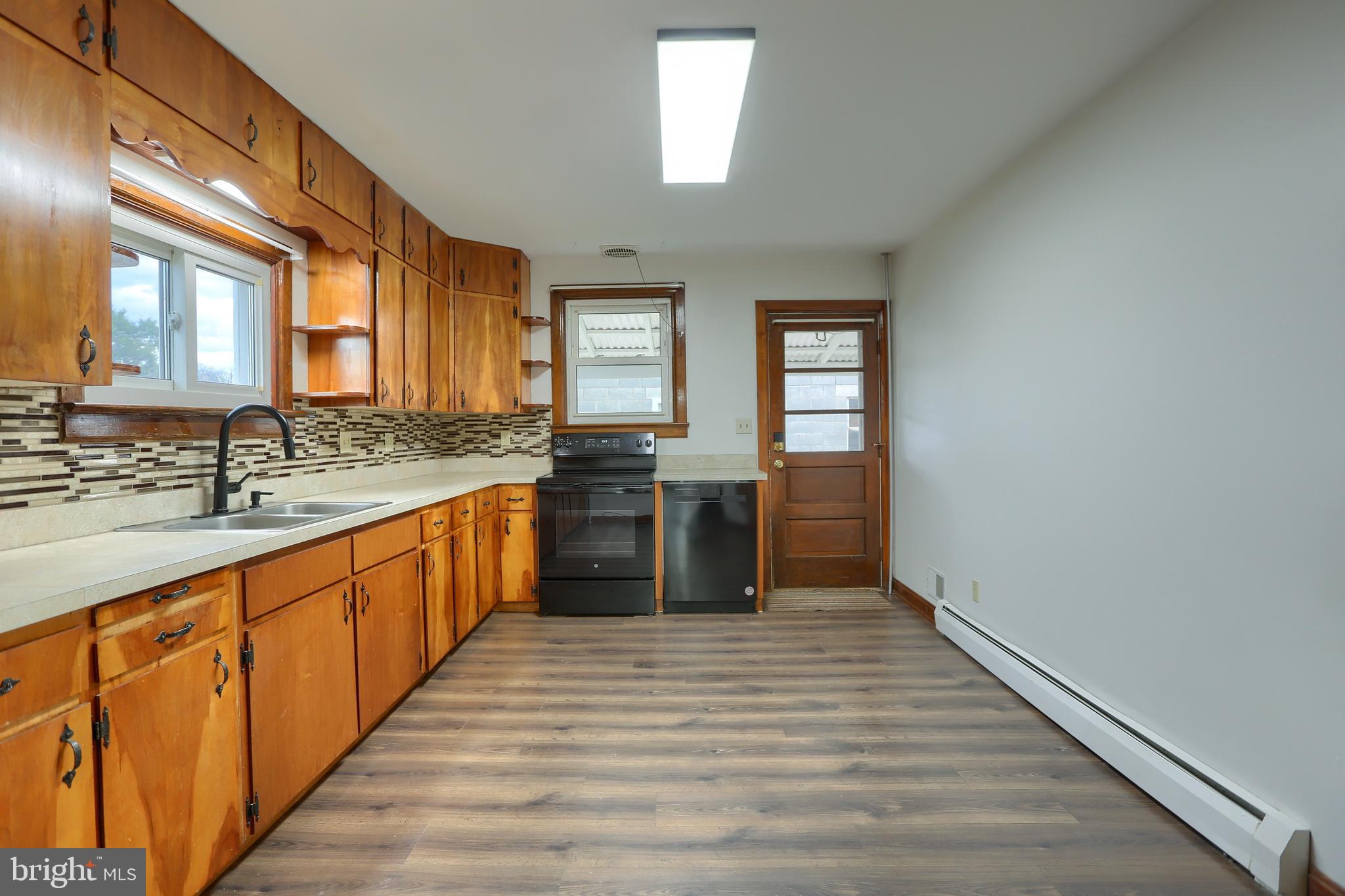 338 Locust Street Halifax, PA 17032 - Photo 14 of 43 a large kitchen with wooden floor and a window