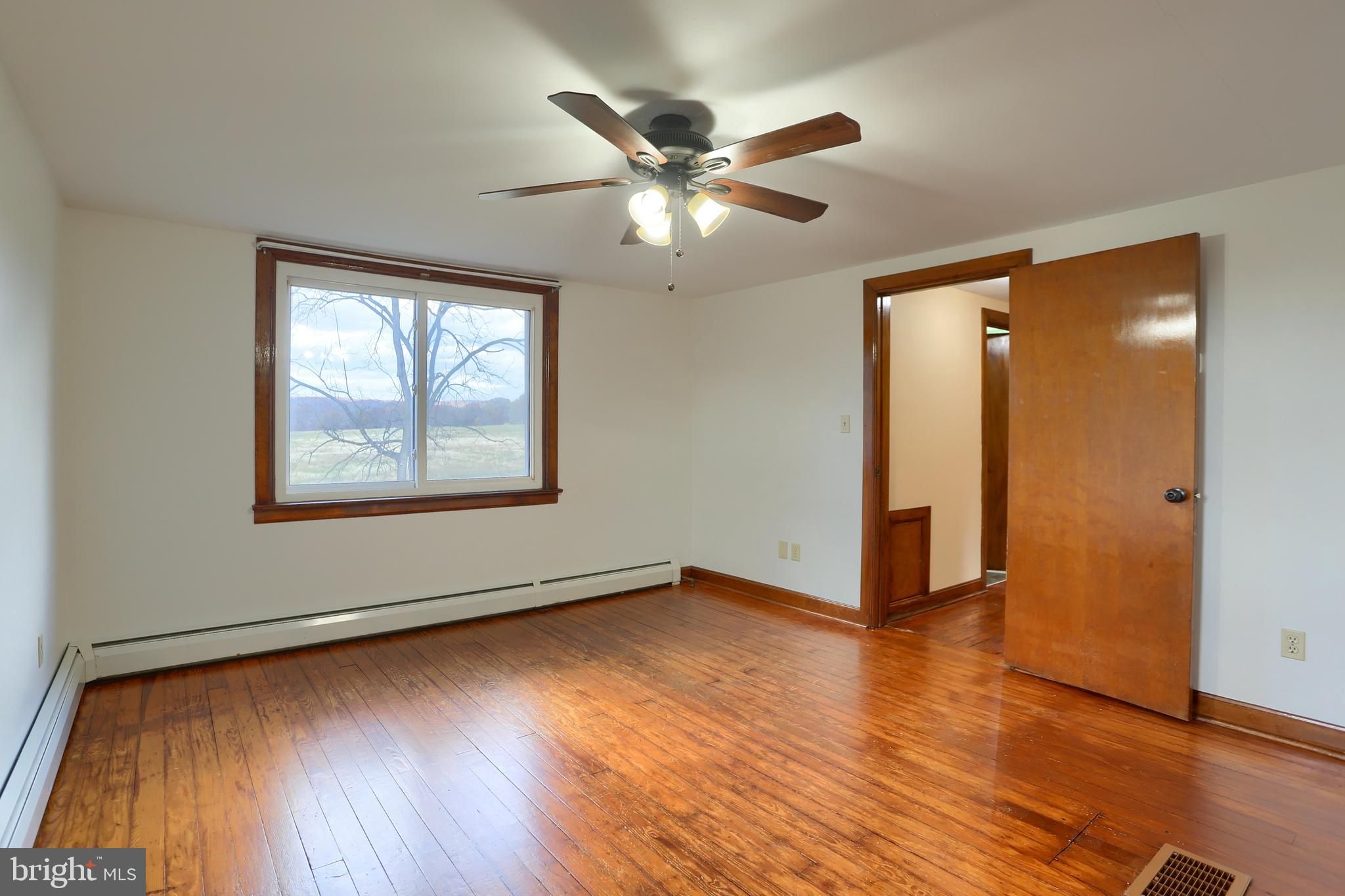 338 Locust Street Halifax, PA 17032 - Photo 24 of 43 an empty room with wooden floor fan and windows