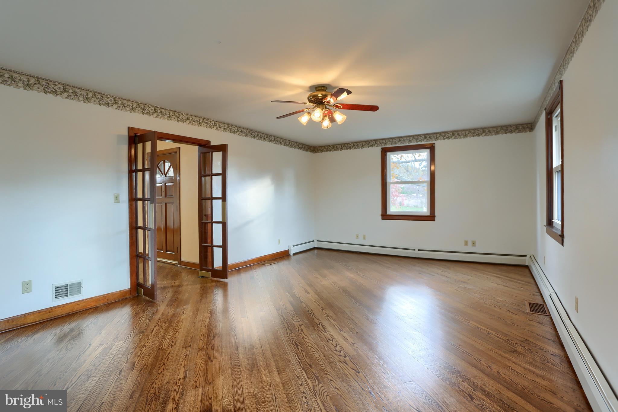 338 Locust Street Halifax, PA 17032 - Photo 6 of 43 an empty room with wooden floor and chandelier fan