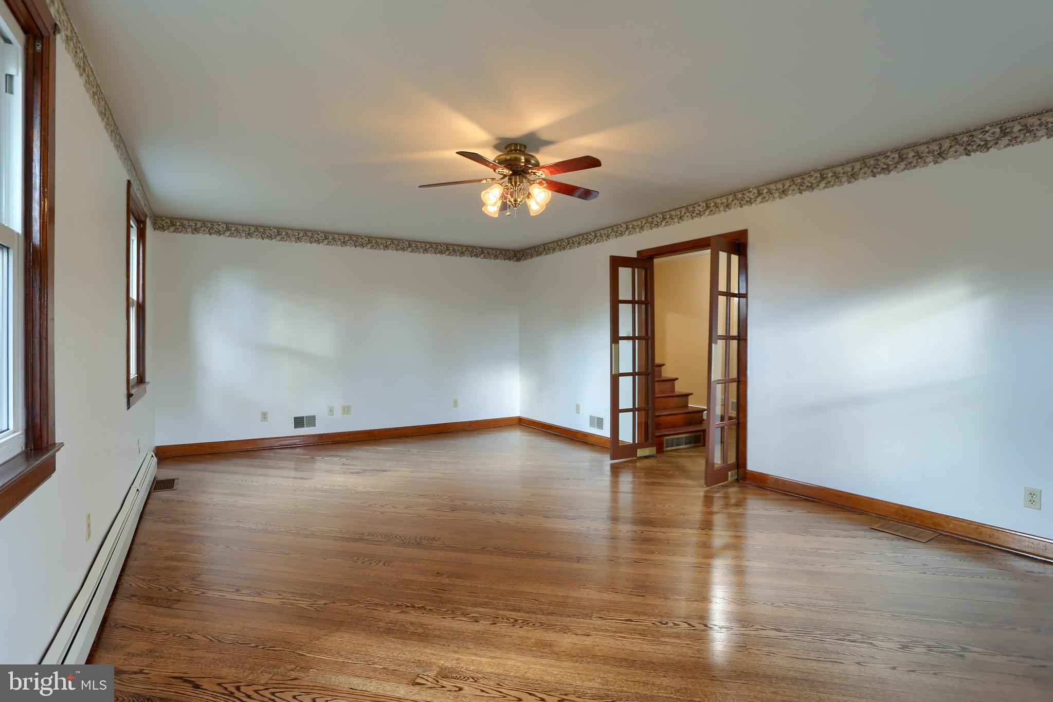 338 Locust Street Halifax, PA 17032 - Photo 7 of 43 a view of an empty room with window and wooden floor