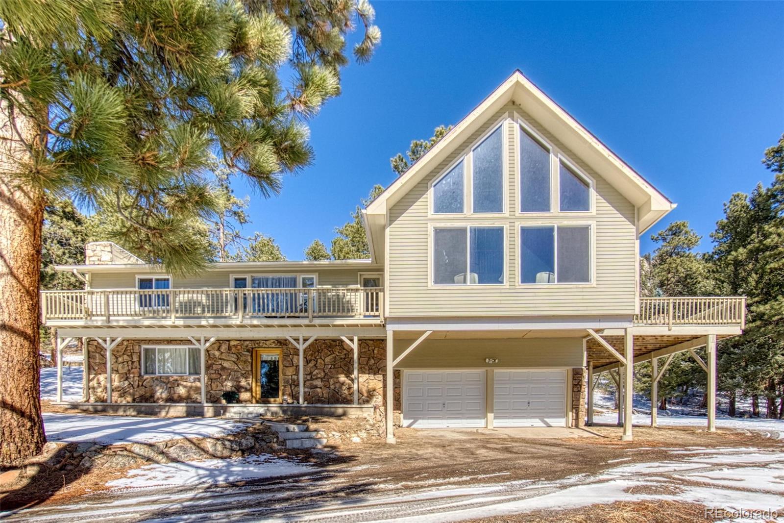 25681 Mosier Circle Conifer, CO 80433 - Photo 1 of 29 a front view of a house with yard and balcony