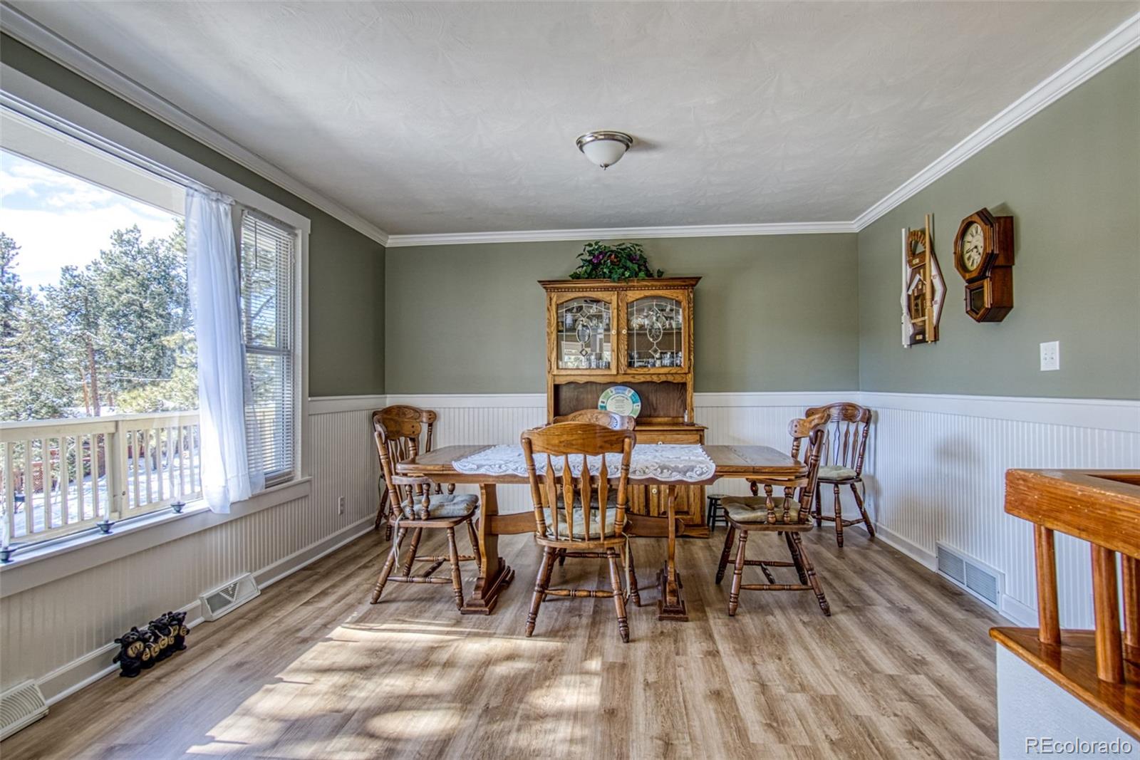 25681 Mosier Circle Conifer, CO 80433 - Photo 14 of 29 a view of a dining room with furniture window and wooden floor