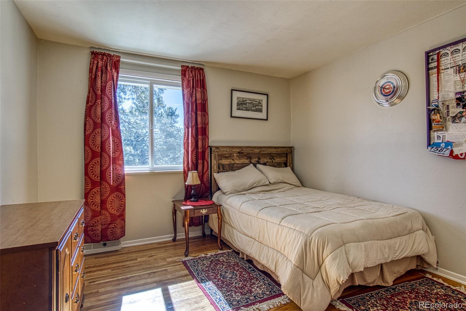 25681 Mosier Circle Conifer, CO 80433 - Photo 21 of 29 a bedroom with a bed and a window