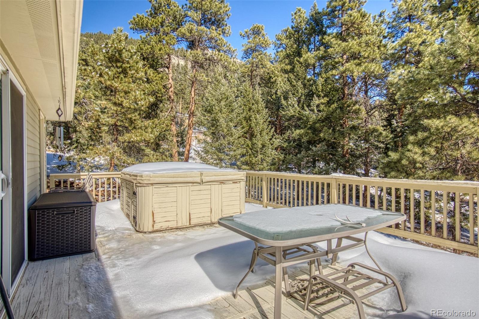 25681 Mosier Circle Conifer, CO 80433 - Photo 26 of 29 a view of a chairs and table on the deck