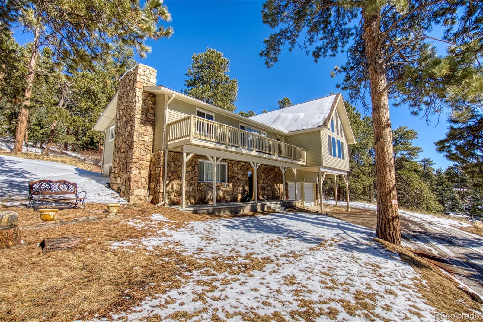 25681 Mosier Circle Conifer, CO 80433 - Photo 5 of 29 a front view of a building with a yard