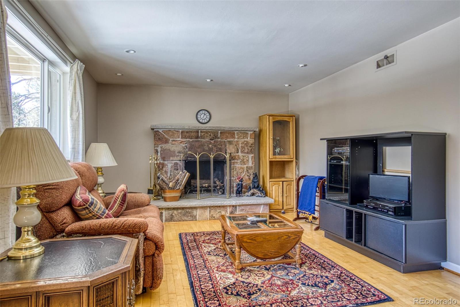 25681 Mosier Circle Conifer, CO 80433 - Photo 6 of 29 a living room with fireplace furniture and a flat screen tv