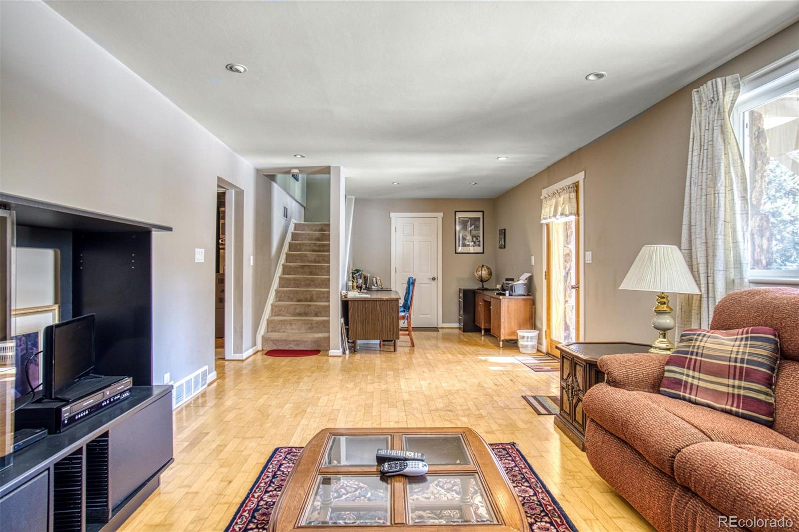 25681 Mosier Circle Conifer, CO 80433 - Photo 7 of 29 a living room with furniture and a flat screen tv