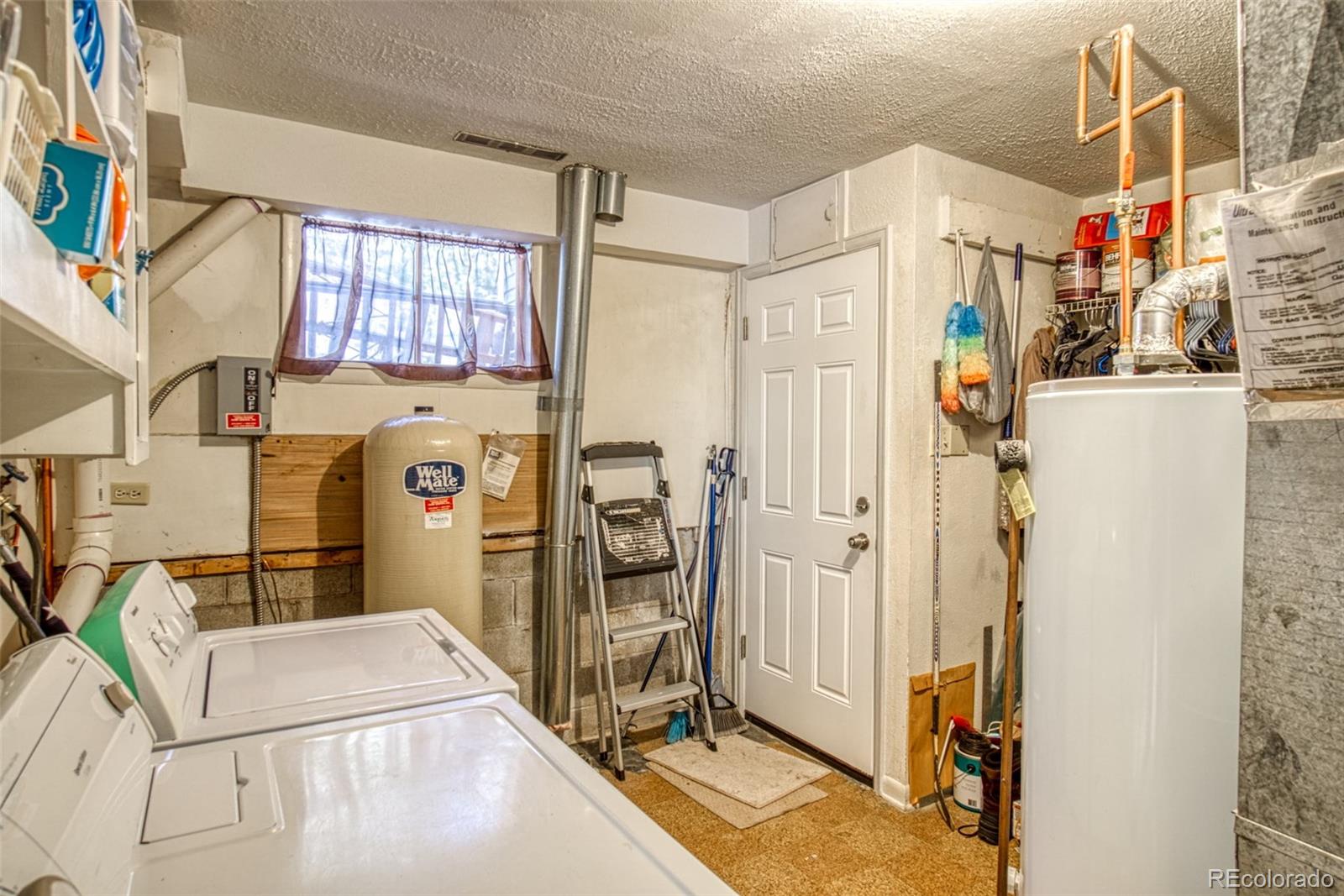 25681 Mosier Circle Conifer, CO 80433 - Photo 10 of 29 a utility room with dryer and washer