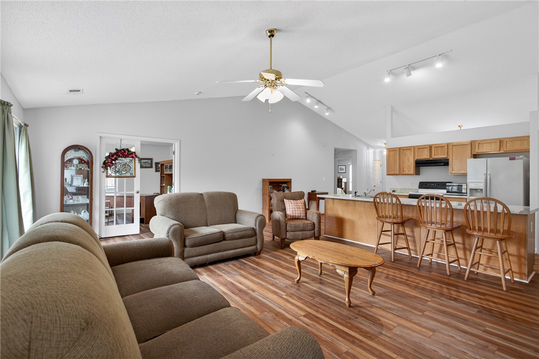 207 Hunters Lane Anderson, SC 29625 - Photo 11 of 46 An inviting open-concept area blends living space with a kitchen island, creating a versatile entertaining flow.