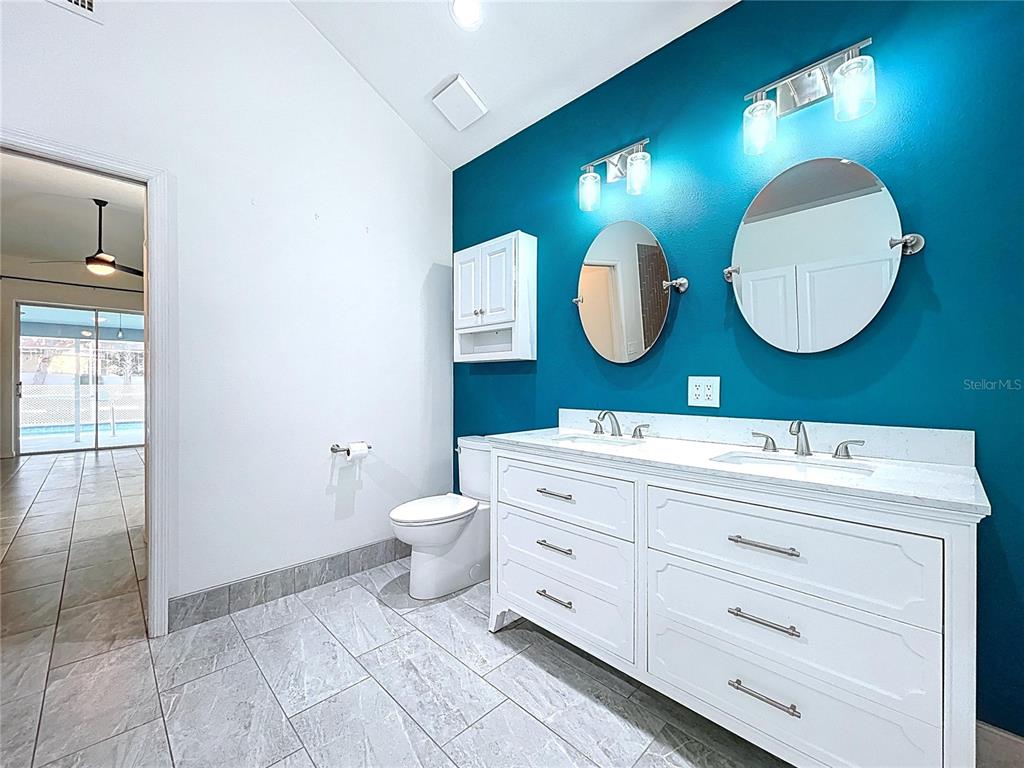 18812 Bascomb Lane Hudson, FL 34667 - Photo 41 of 57 a bathroom with a toilet sink and mirror