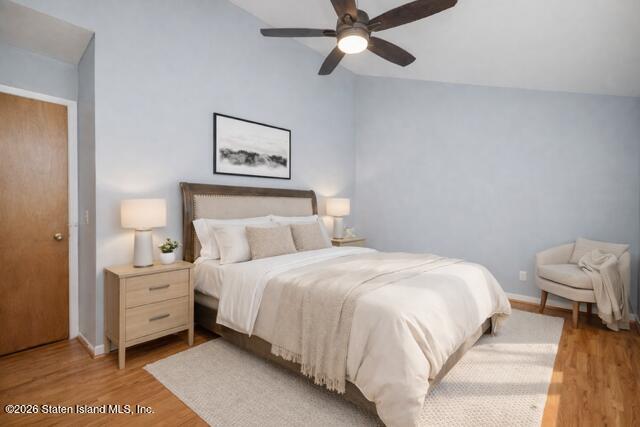 101 Beach Street Staten Island, NY 10304 - Photo 11 of 20 a bedroom with a bed and a lamp