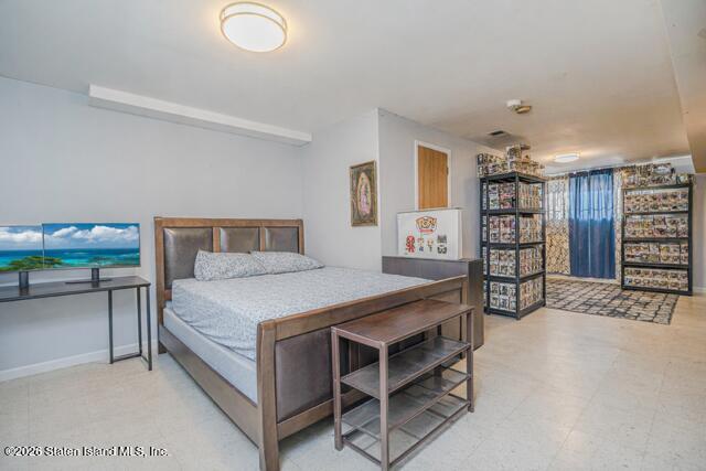 101 Beach Street Staten Island, NY 10304 - Photo 17 of 20 a bedroom with a bed and a chair