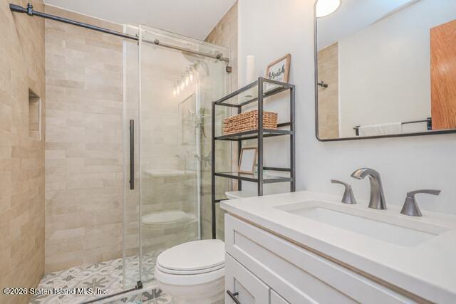 101 Beach Street Staten Island, NY 10304 - Photo 19 of 20 a bathroom with a sink a mirror a toilet and shower