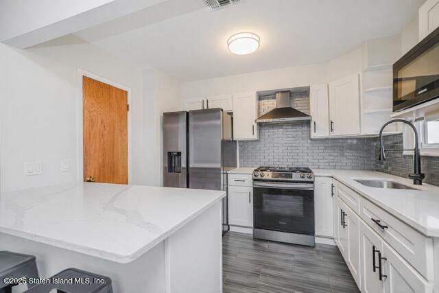 101 Beach Street Staten Island, NY 10304 - Photo 7 of 20 a kitchen with stainless steel appliances granite countertop a sink stove and refrigerator