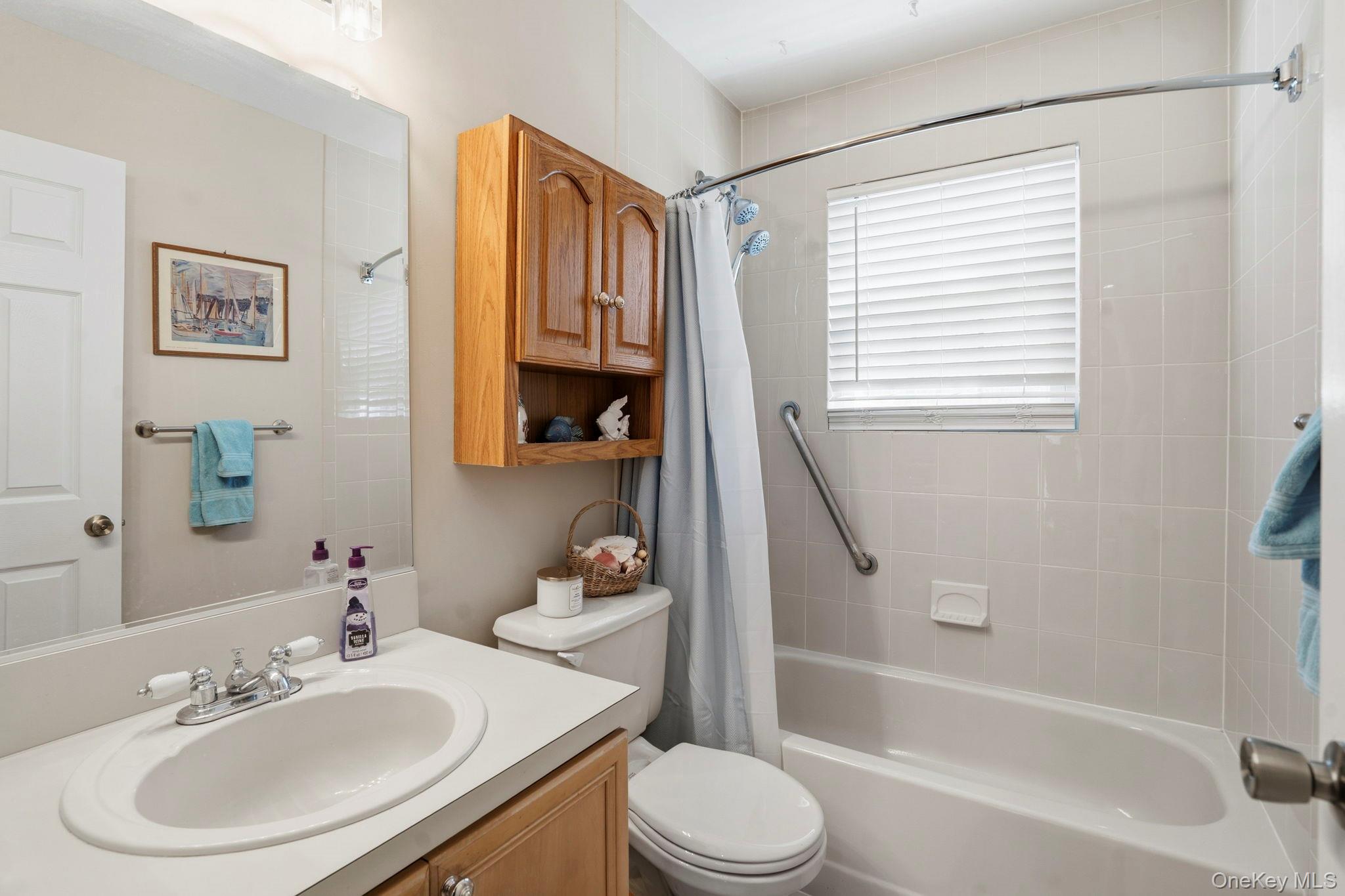 11 Chipmunk Trail Coram, NY 11727 - Photo 15 of 21 a bathroom with a sink toilet and shower
