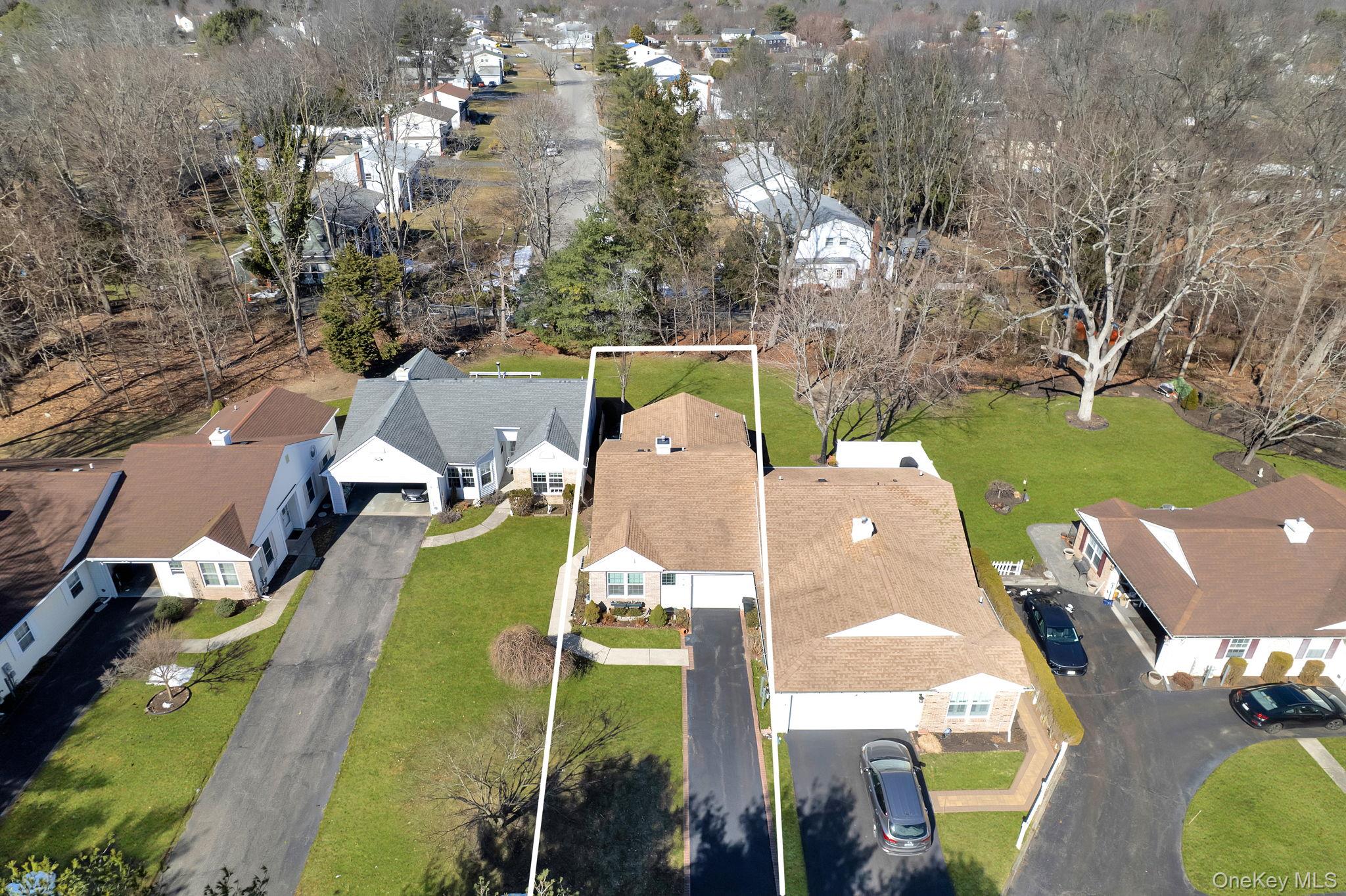 11 Chipmunk Trail Coram, NY 11727 - Photo 4 of 21 an aerial view of a house with a garden and lake view