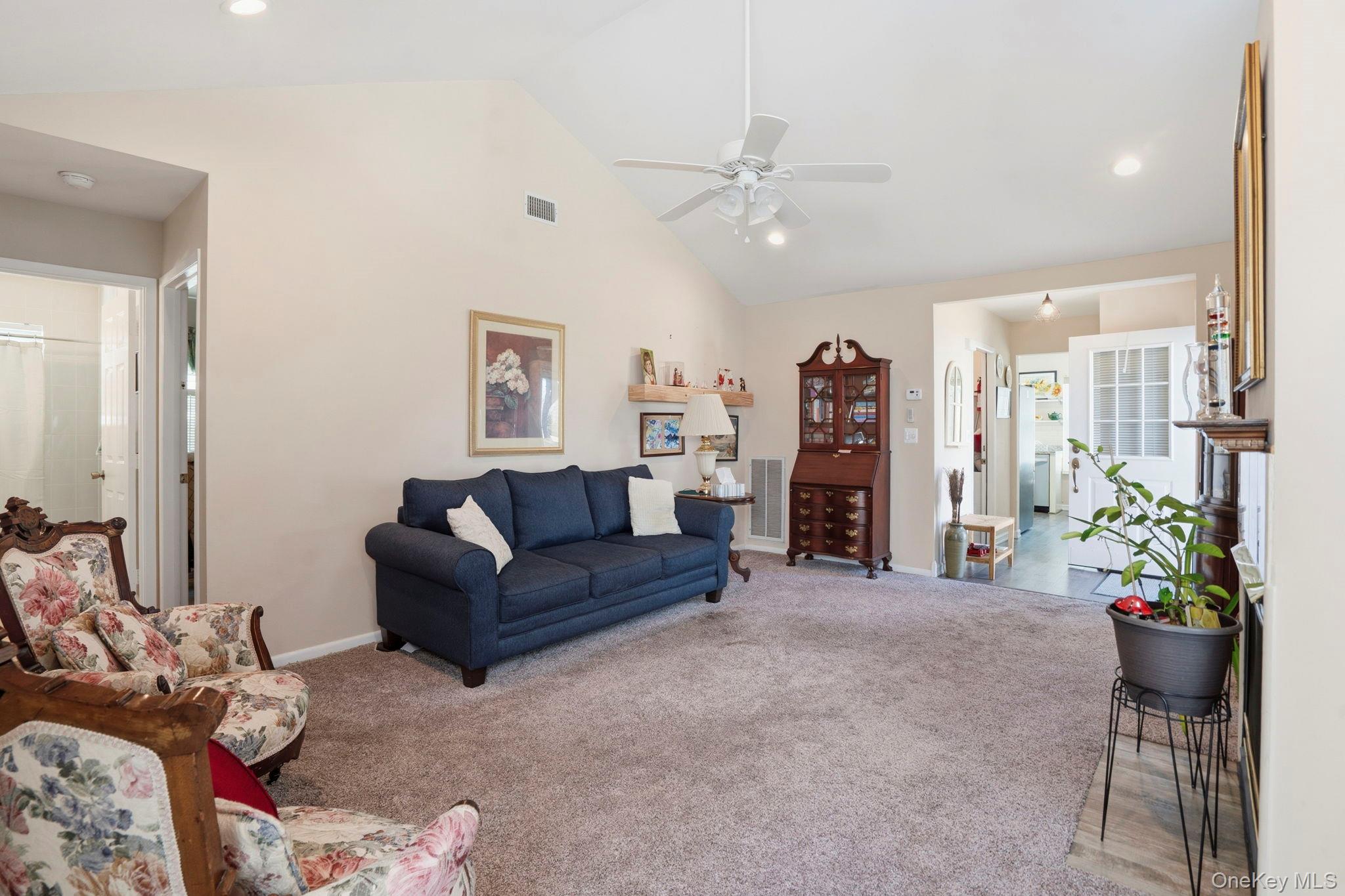 11 Chipmunk Trail Coram, NY 11727 - Photo 8 of 21 a living room with furniture and a chandelier