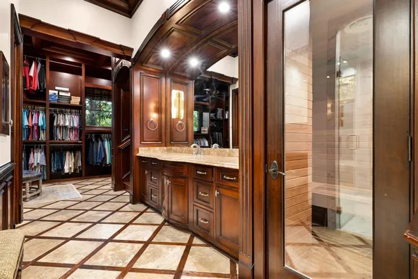 a spacious bedroom with a large bed and a flat screen tv