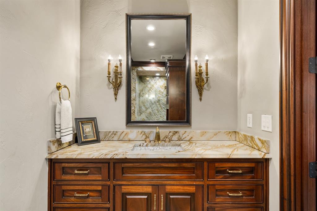 6413 Old Gate Road Plano, TX 75024 - Photo 32 of 38 a bathroom with a granite countertop sink and a mirror