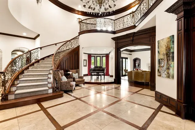 a dining room with furniture and a chandelier