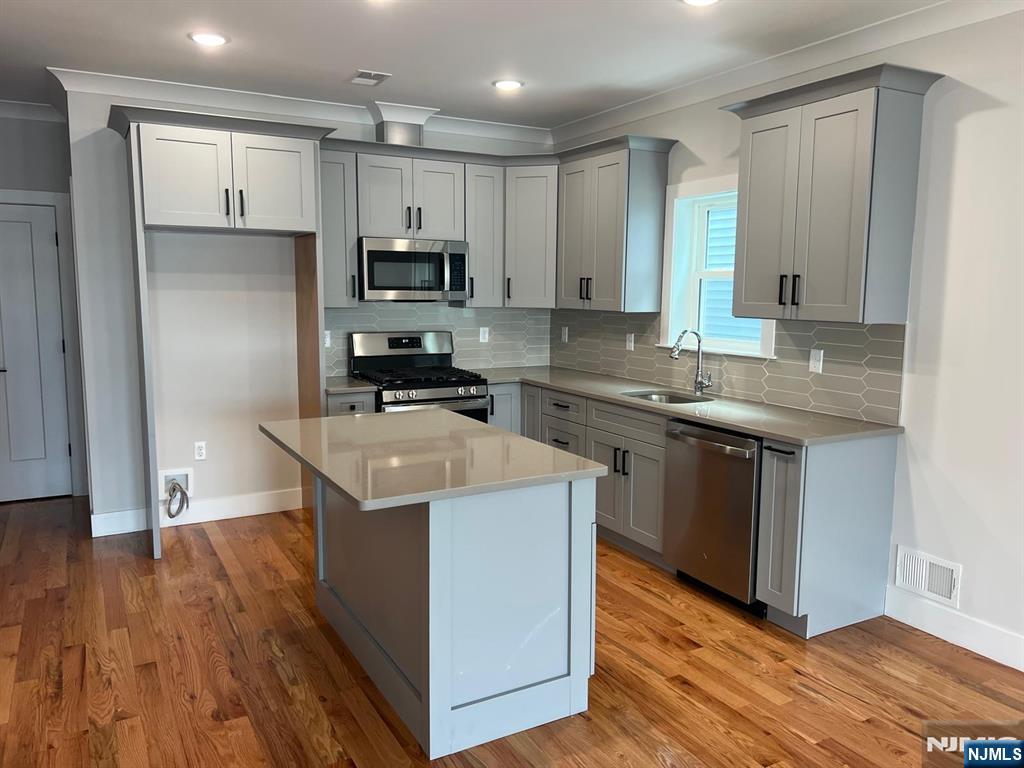 1060 Magnolia Avenue Elizabeth, NJ 07201 - Photo 12 of 22 a kitchen with stainless steel appliances granite countertop a sink stove and refrigerator