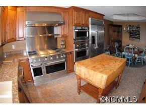 2170 Rock Road Rutherfordton, NC 28139 - Photo 16 of 17 a kitchen with a stove a refrigerator and a dining table