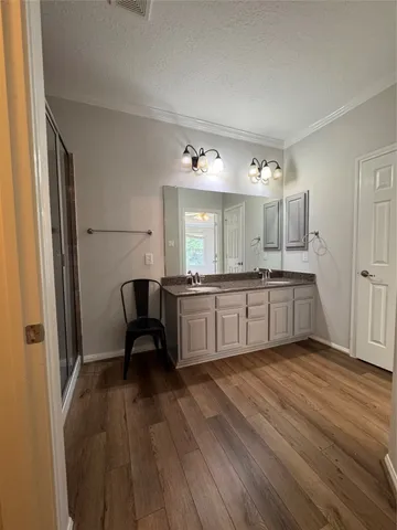 a large kitchen with a lot of counter space and a wooden floor