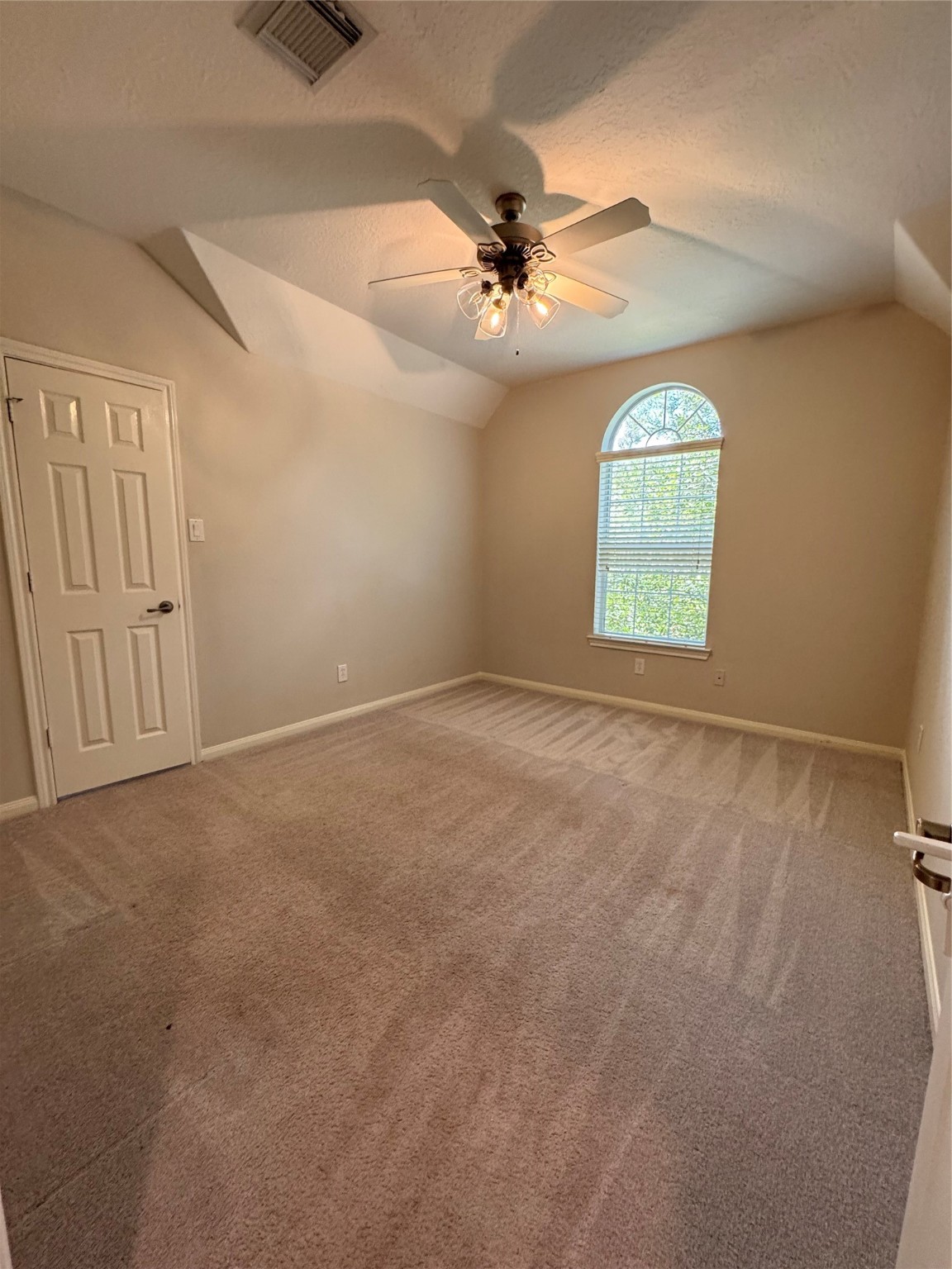 137 East Montfair Boulevard Spring, TX 77382 - Photo 20 of 23 an empty room with a chandelier fan and windows