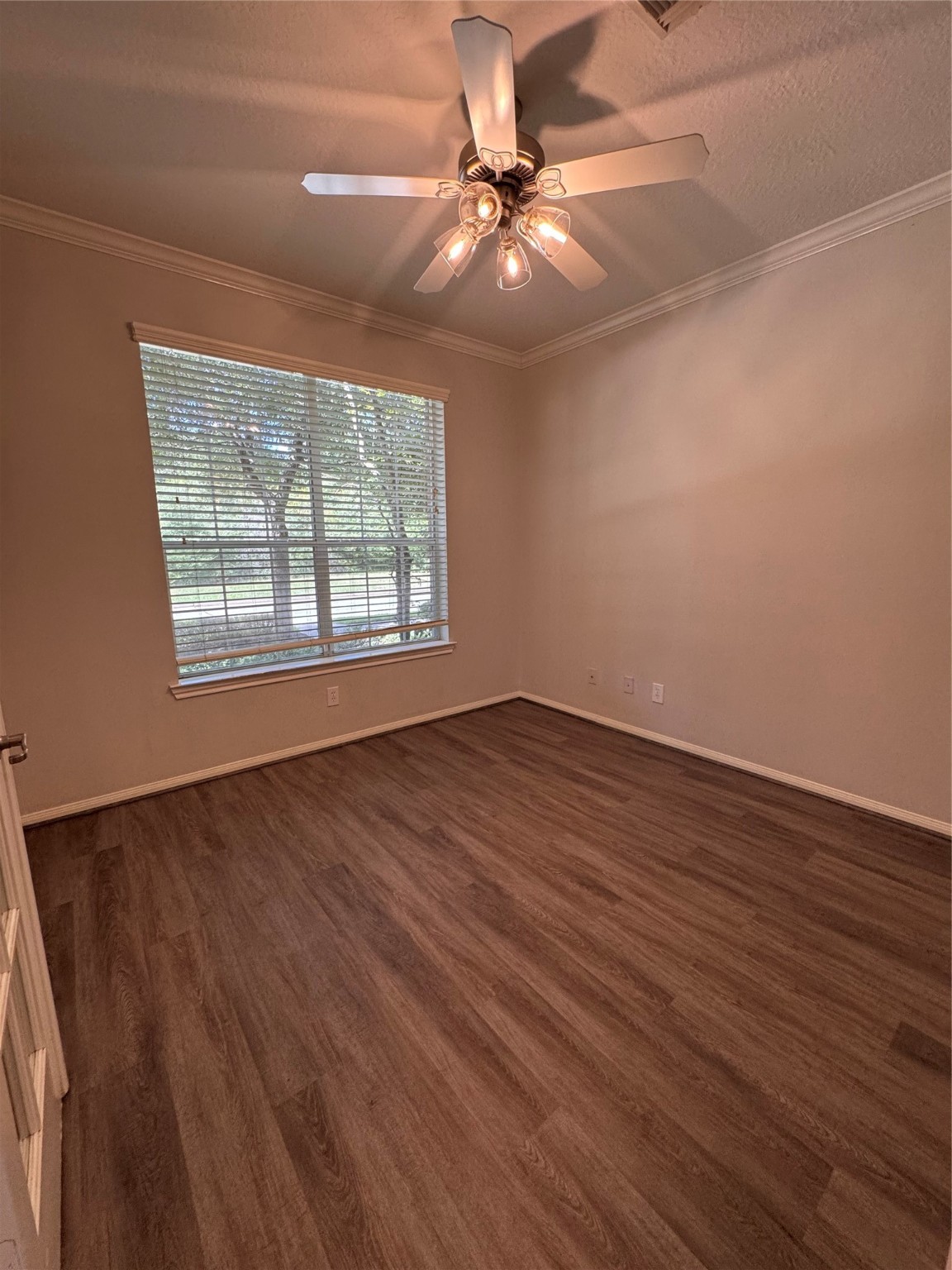 137 East Montfair Boulevard Spring, TX 77382 - Photo 4 of 23 an empty room with wooden floor fan and windows