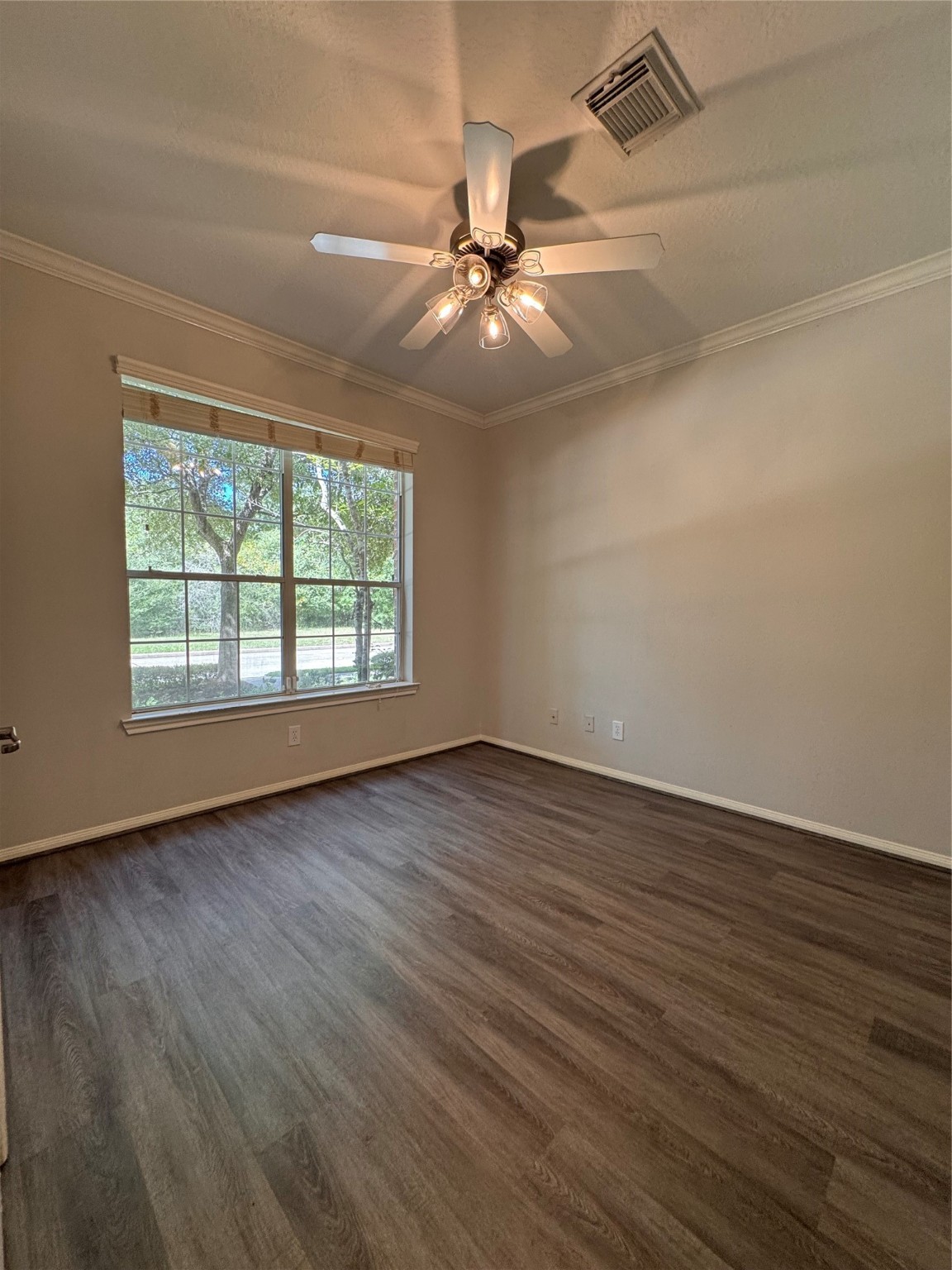 137 East Montfair Boulevard Spring, TX 77382 - Photo 8 of 23 an empty room with wooden floor chandelier fan and windows