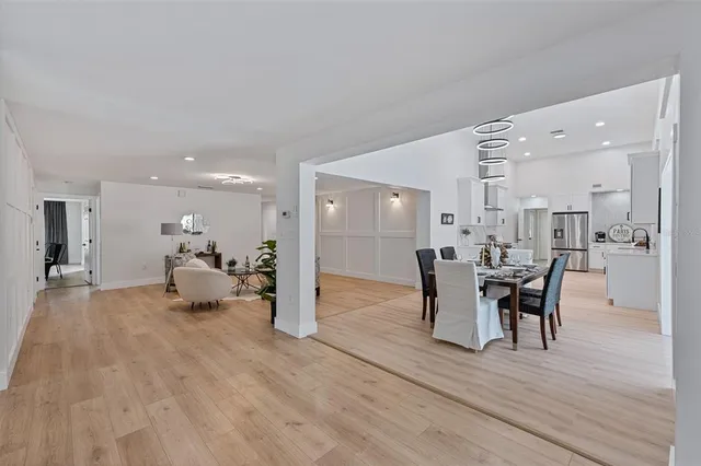 a dining room with furniture and wooden floor