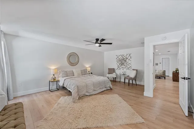a bedroom with a bed and chandelier