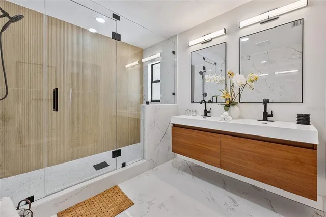 a bathroom with a tub sink and mirror