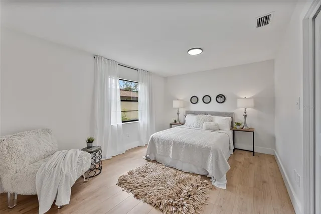 a bedroom with a large bed and a window