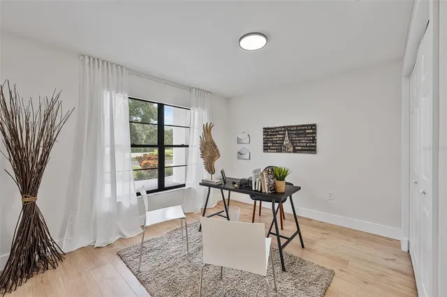 a living room with furniture and next to a window