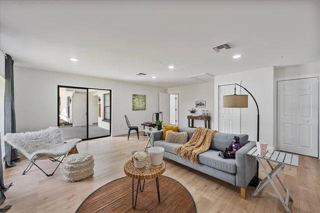 a living room with furniture and wooden floor