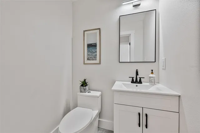 a bathroom with a toilet a sink and mirror