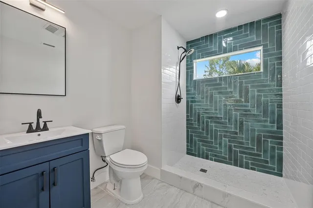 a bathroom with a toilet a sink and shower