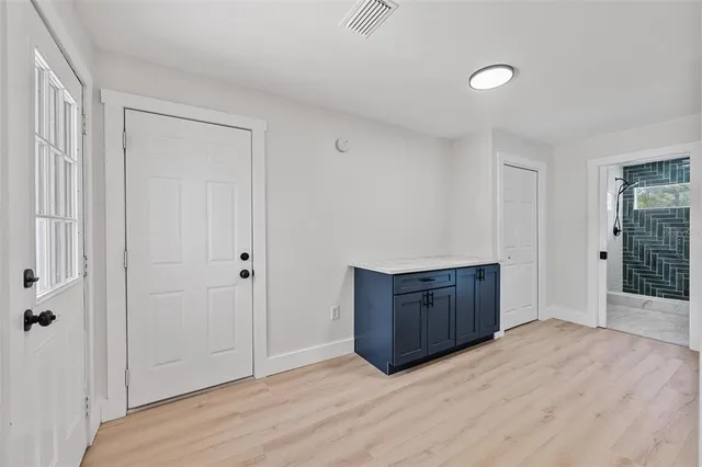 a room view with wooden floor and cabinet