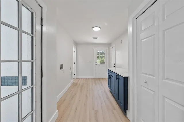 a view of a hallway with wooden floor and staircase