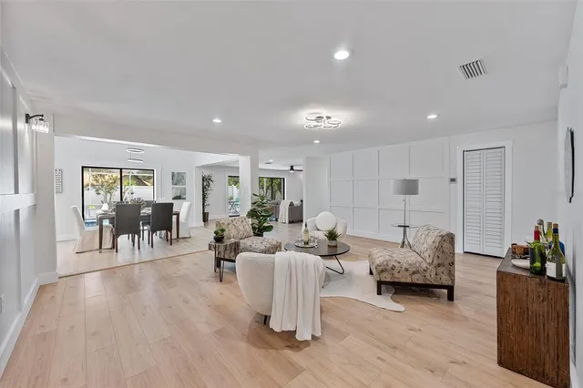a living room with furniture wooden floor and a large window