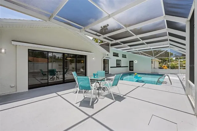 a view of a patio with table and chairs and potted plants