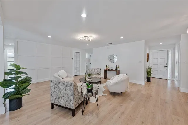 a living room with furniture and a potted plant