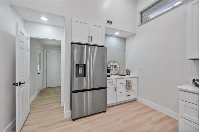 a kitchen with a refrigerator and a stove
