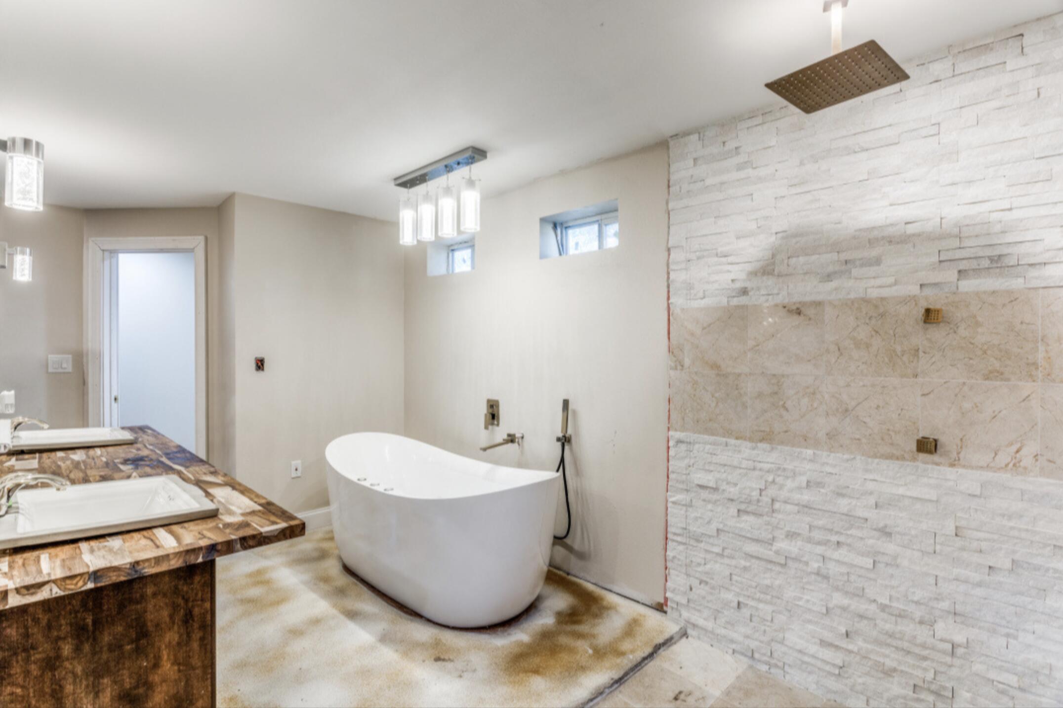 610 Pleasant Grove Road Elgin, TX 78621 - Photo 15 of 25 Full bathroom with double vanity, a walk in shower, and a freestanding bath