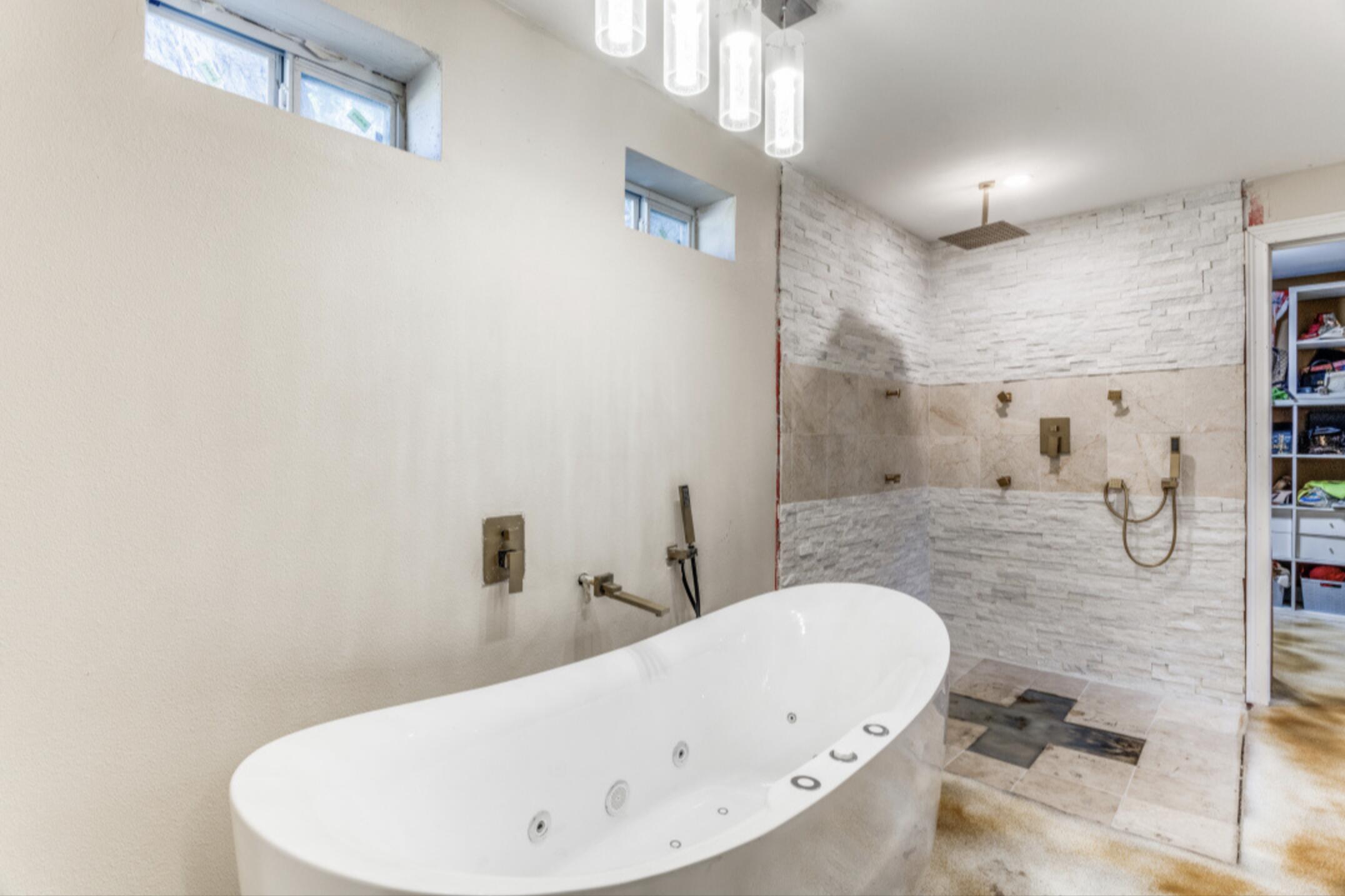 610 Pleasant Grove Road Elgin, TX 78621 - Photo 16 of 25 Full bath with a soaking tub and a walk in shower