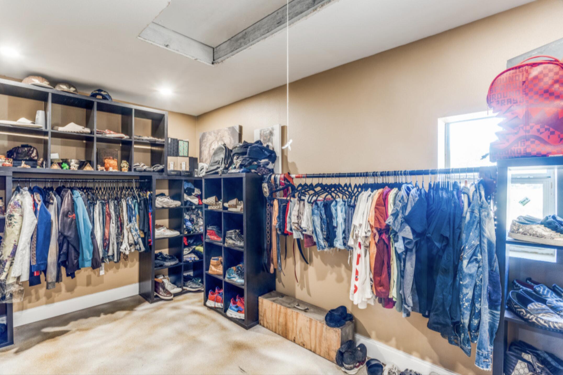 610 Pleasant Grove Road Elgin, TX 78621 - Photo 18 of 25 Walk in closet with attic access and light colored carpet