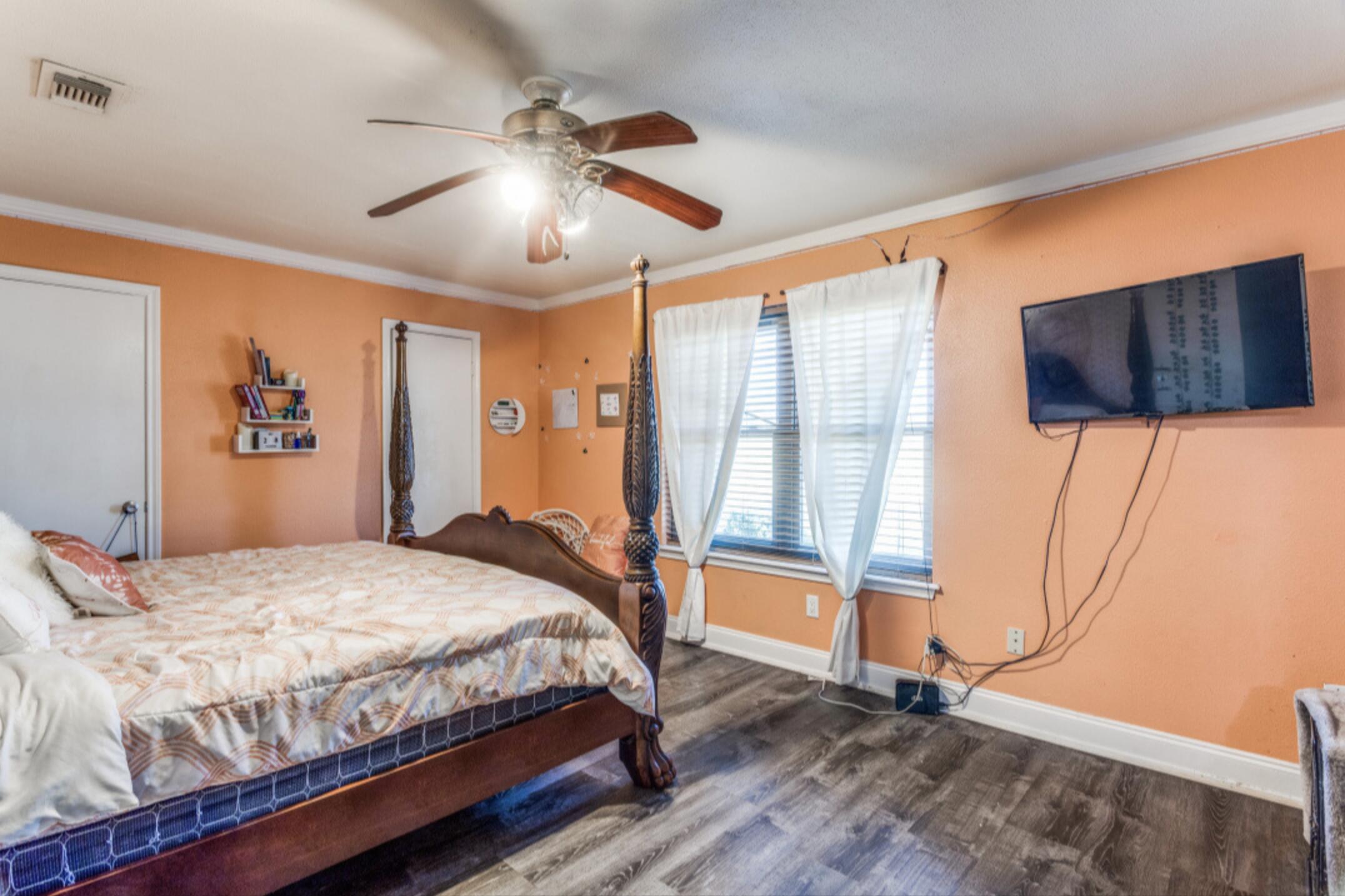 610 Pleasant Grove Road Elgin, TX 78621 - Photo 19 of 25 Bedroom with ornamental molding, dark wood-type flooring, and ceiling fan