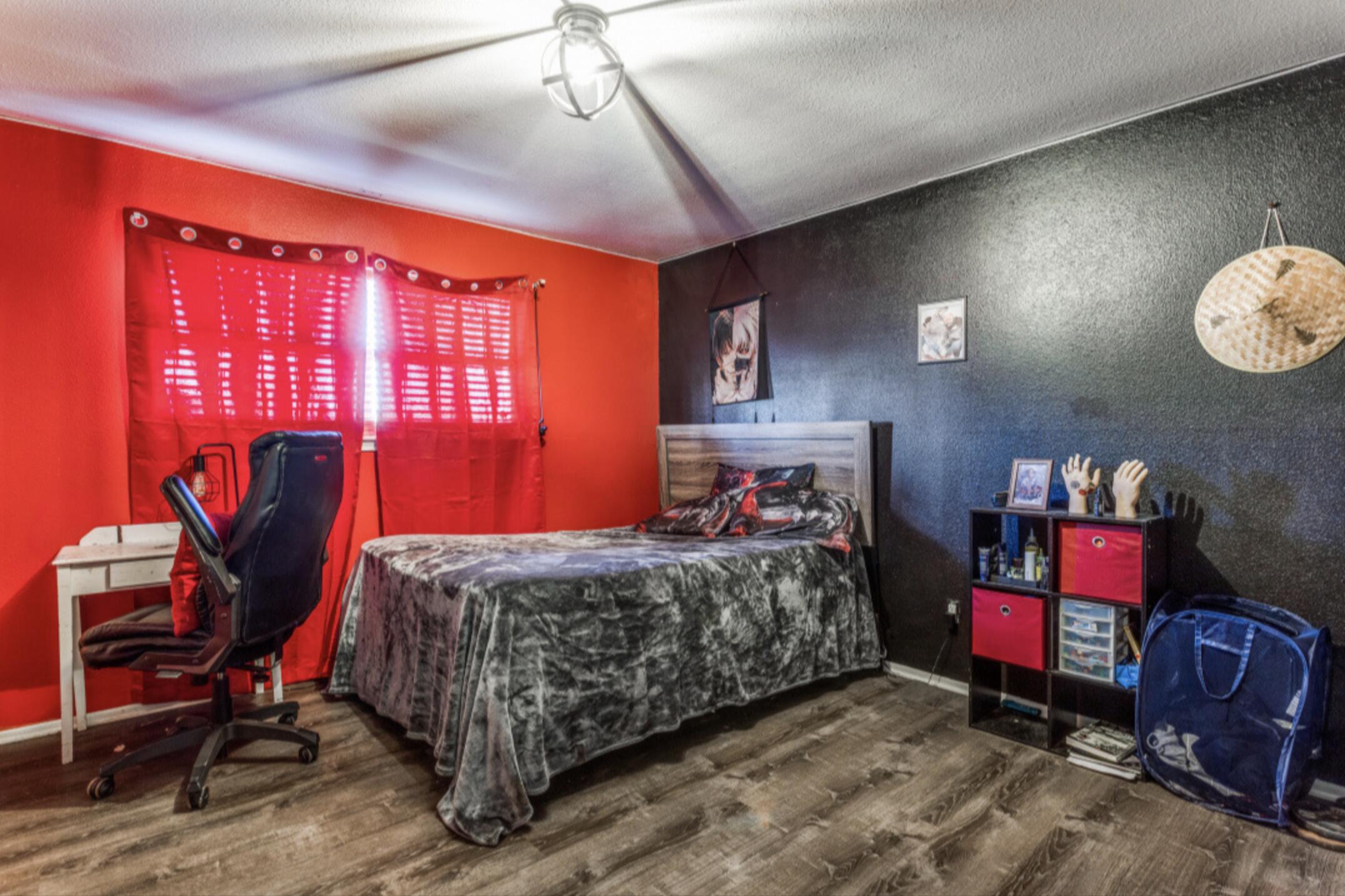 610 Pleasant Grove Road Elgin, TX 78621 - Photo 21 of 25 Bedroom featuring dark wood finished floors and a textured ceiling